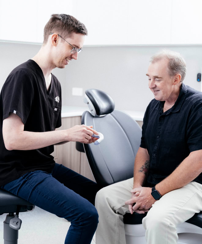 Dentist explaining dental care to a patient.