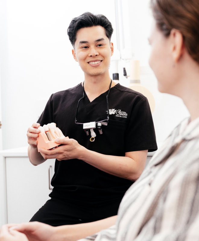 Dentist explaining dental procedure to patient.