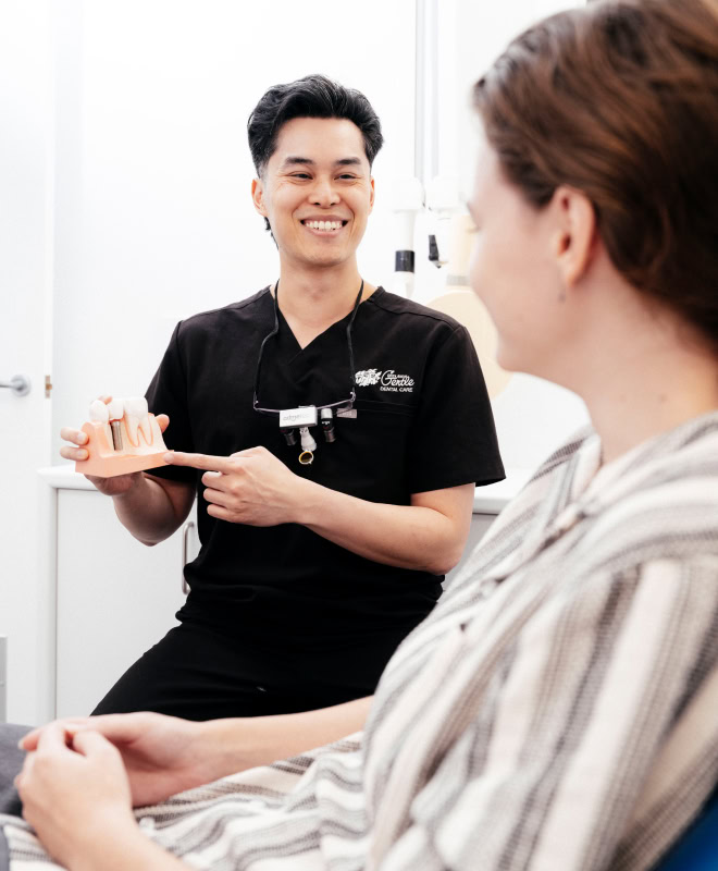 Dentist explaining dental model to patient