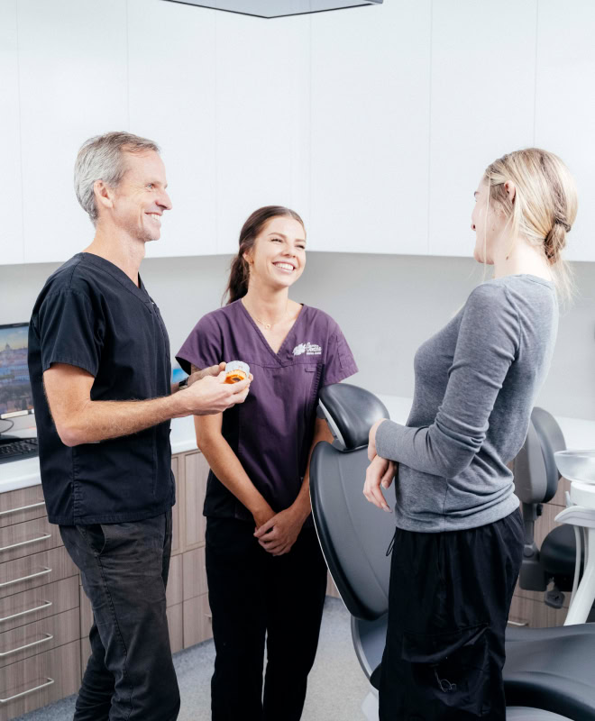 Dental professionals chatting with a patient