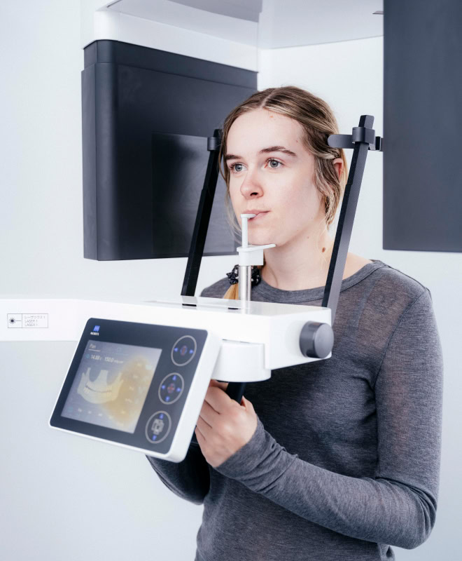 Person using dental imaging machine.