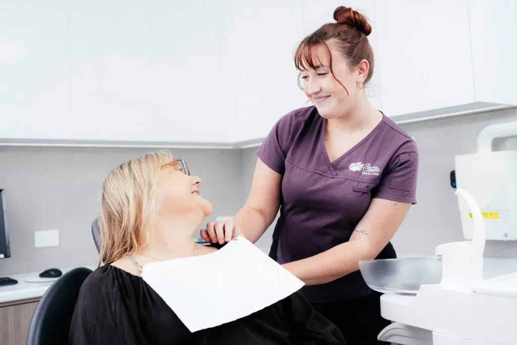 Dentist and patient sharing a friendly moment.