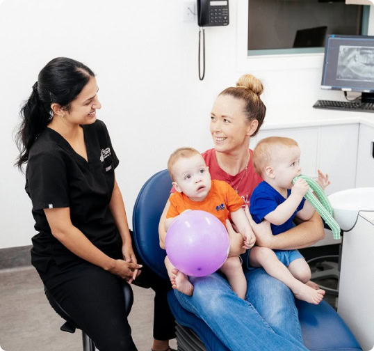 Dentist consultation with mum and two kids.