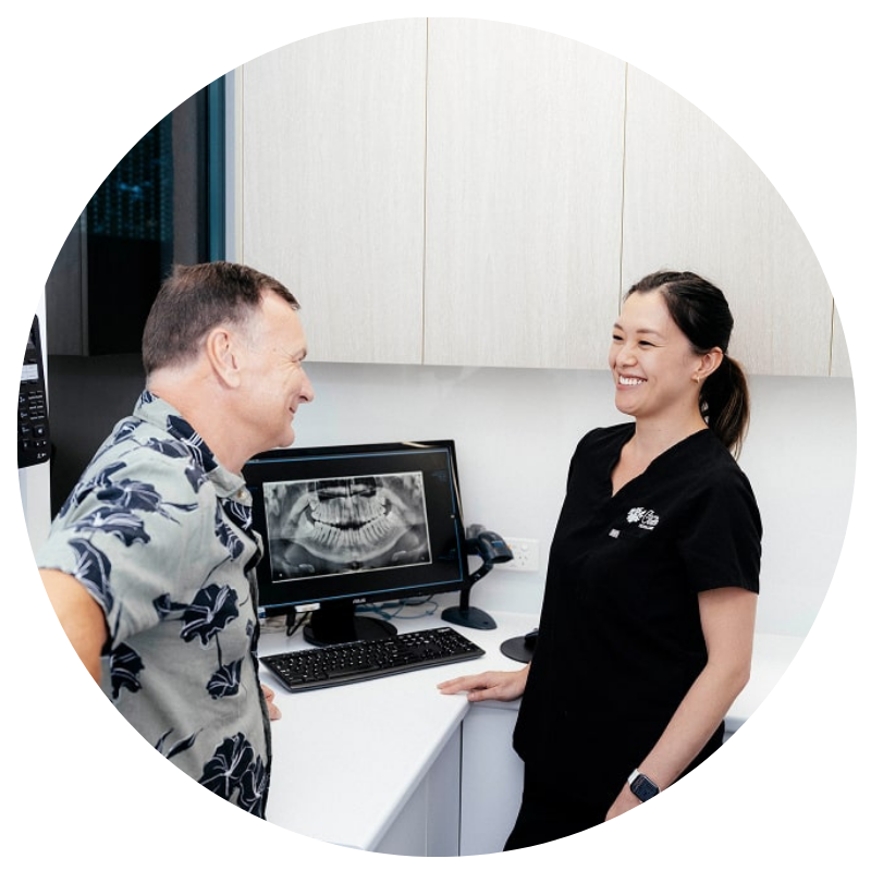 Dentist discussing X-ray with patient in office.